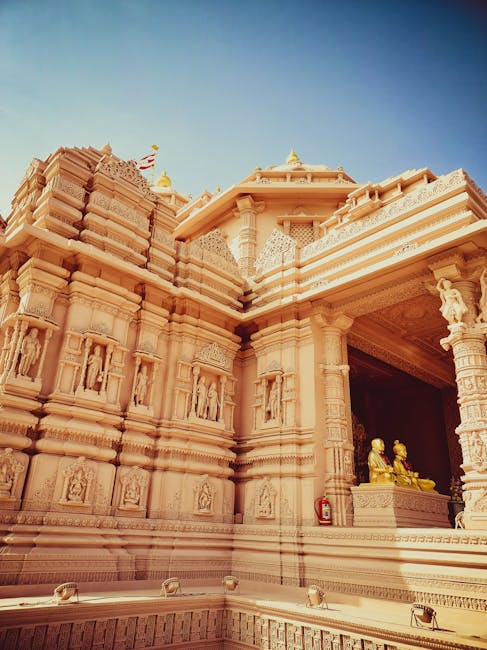 pexels-photo-14774142-14774142-2 Detailed view of the Akshardham Temple in Ahmedabad, showcasing its intricate carvings under a clear blue sky.